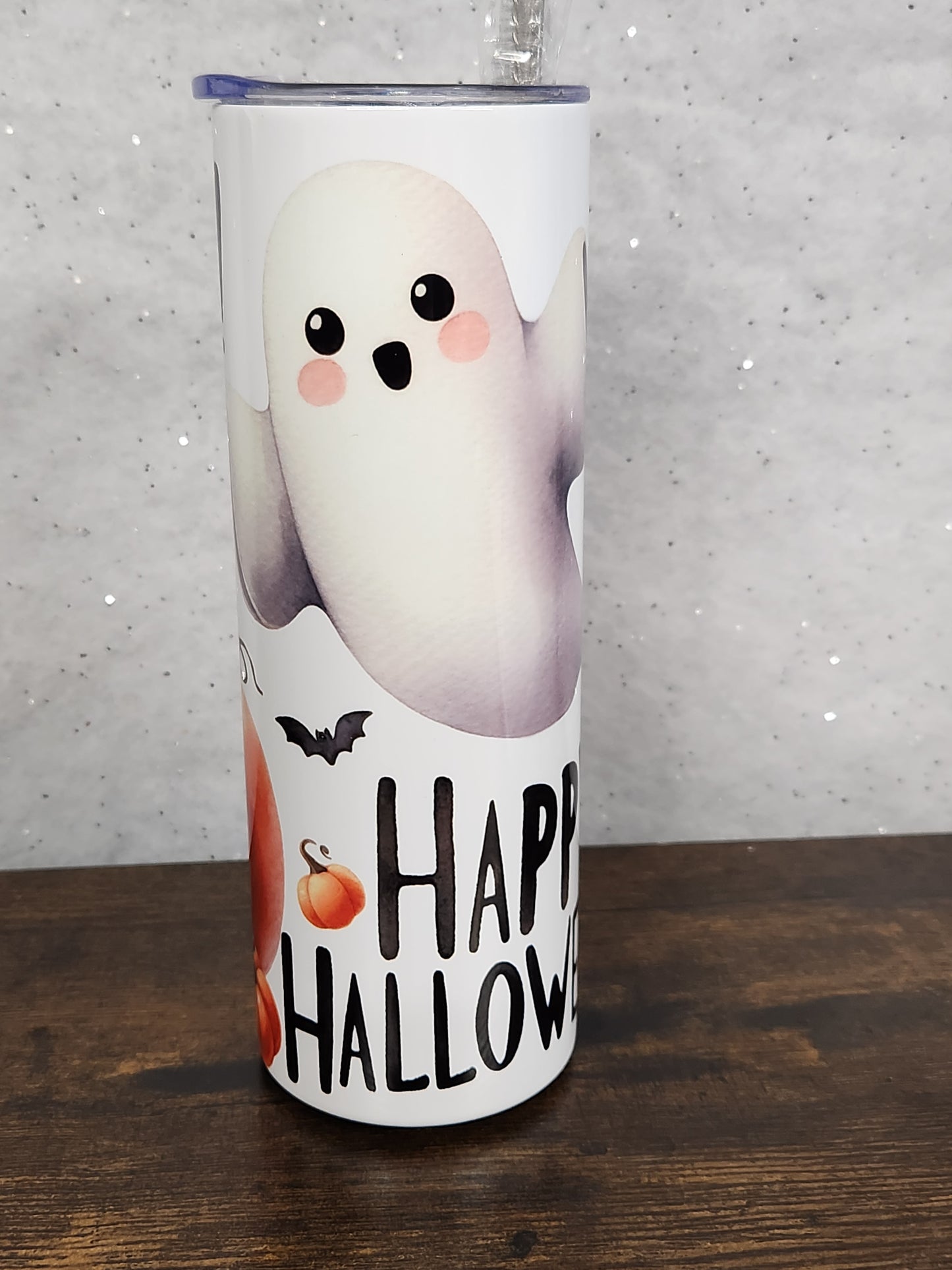 A Halloween Tumbler with a cute ghost and pumpkin design