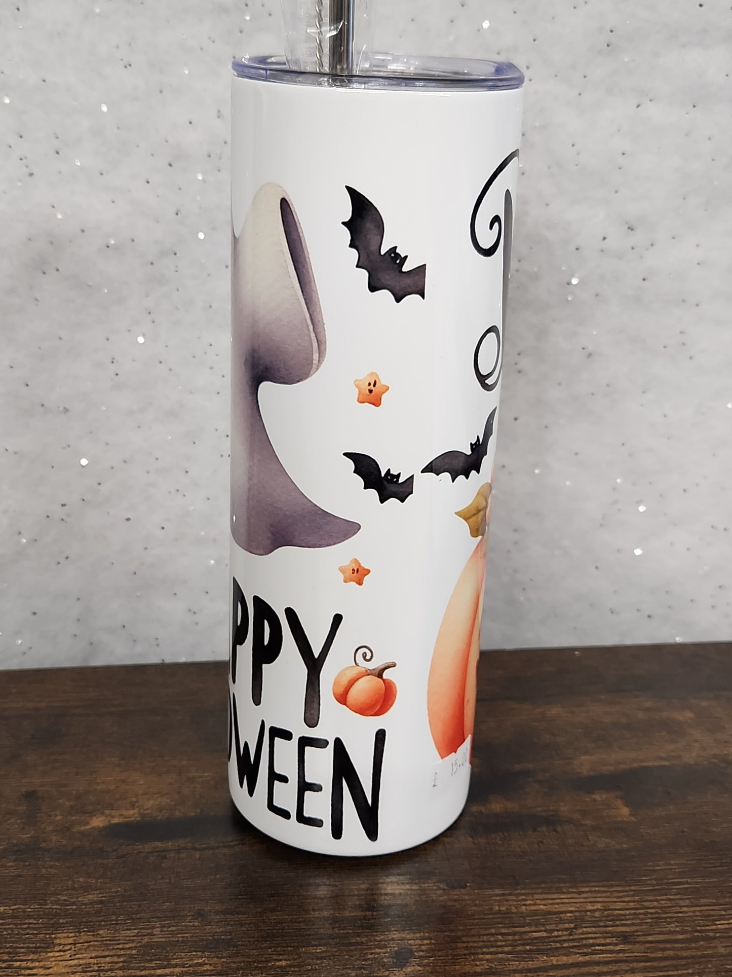 A Halloween Tumbler with a cute ghost and pumpkin design